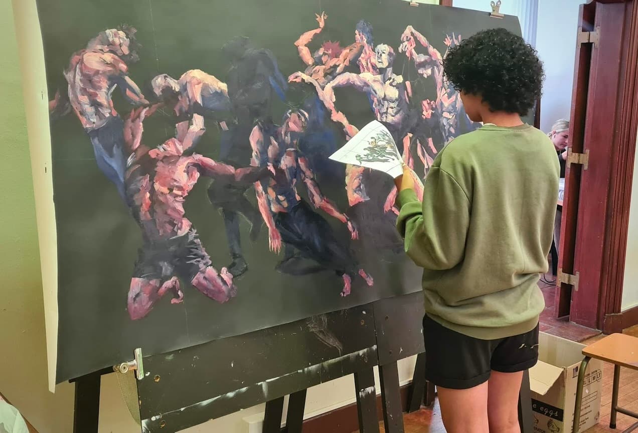 Me painting a large canvas in the studio